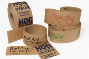 Collection of kraft paper custom tapes featuring printed brand names and logos, with a natural eco-friendly appearance.