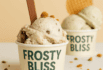 Two Frosty Bliss ice cream cups filled with scoops of ice cream and garnished with crumbs.