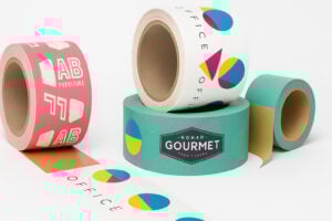 Group of custom tape rolls in vibrant colors and bold geometric patterns, showcasing branding for office and gourmet food services.